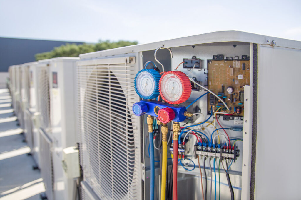 Air conditioning, HVAC service technician using gauges to check